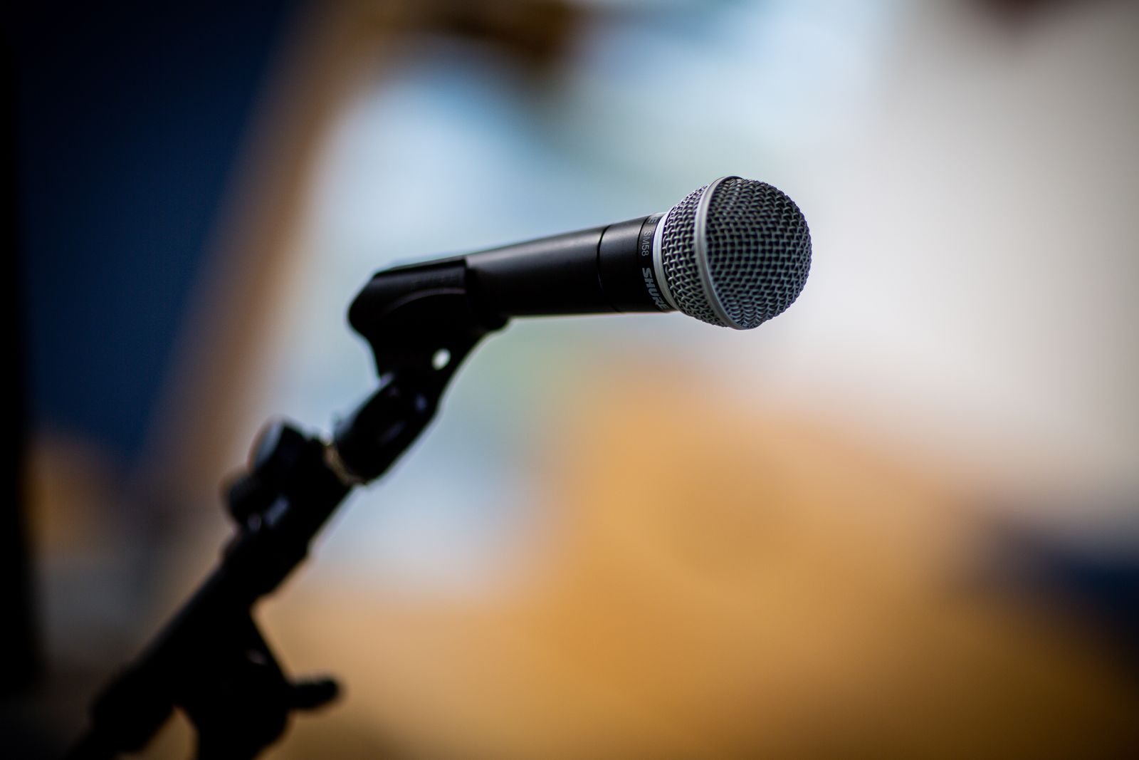 A stage microphone on a stand, used for recording interviews