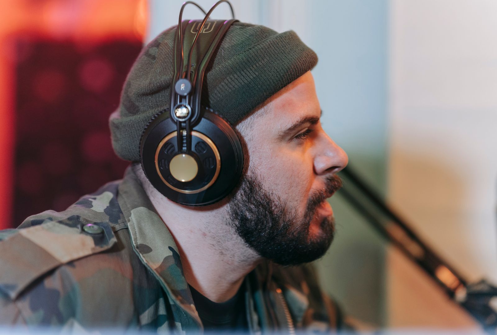 A Ferngrove Wire podcast host wearing headphones, recording an episode in the studio